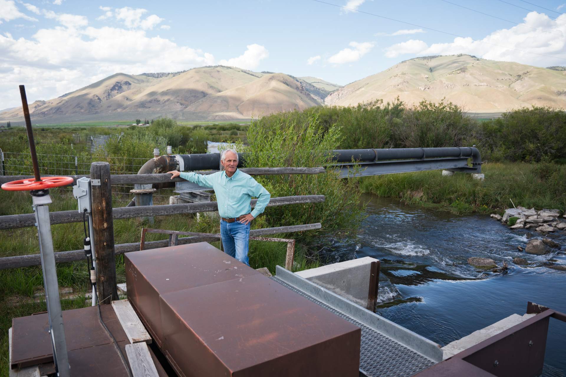 rancher and former Idaho congressman Merrill Beyeler stands near a large fish screen and irrigation pump, a collaborative solution that allowed several ranchers to reconnect tributaries of the Lemhi River that had been dry for nearly 125 years.